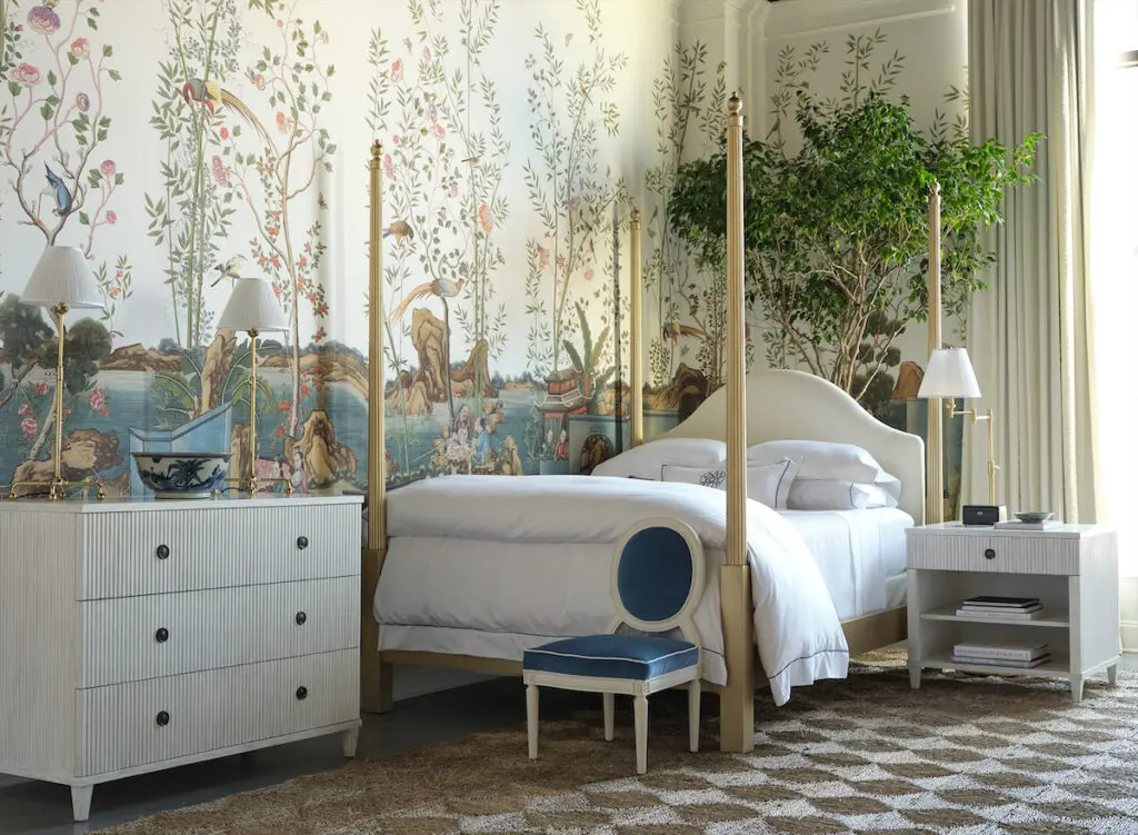 A bed from the Mark D. Sikes for Chaddock collection, dressed in Peacock Alley linens.