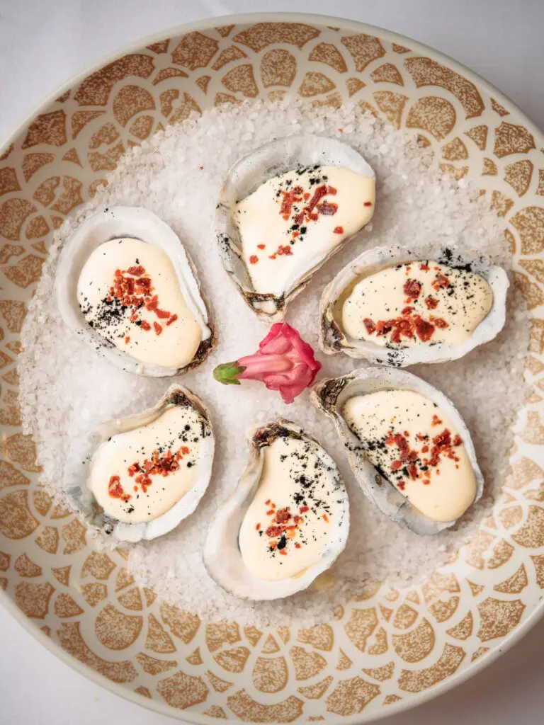 Oyster Carbonara ($24) are a Tavola feature. A half dozen oysters are topped with the rich four-ingredient sauce made with eggs, black pepper, pecorino Romano and lardons of cured pork.
