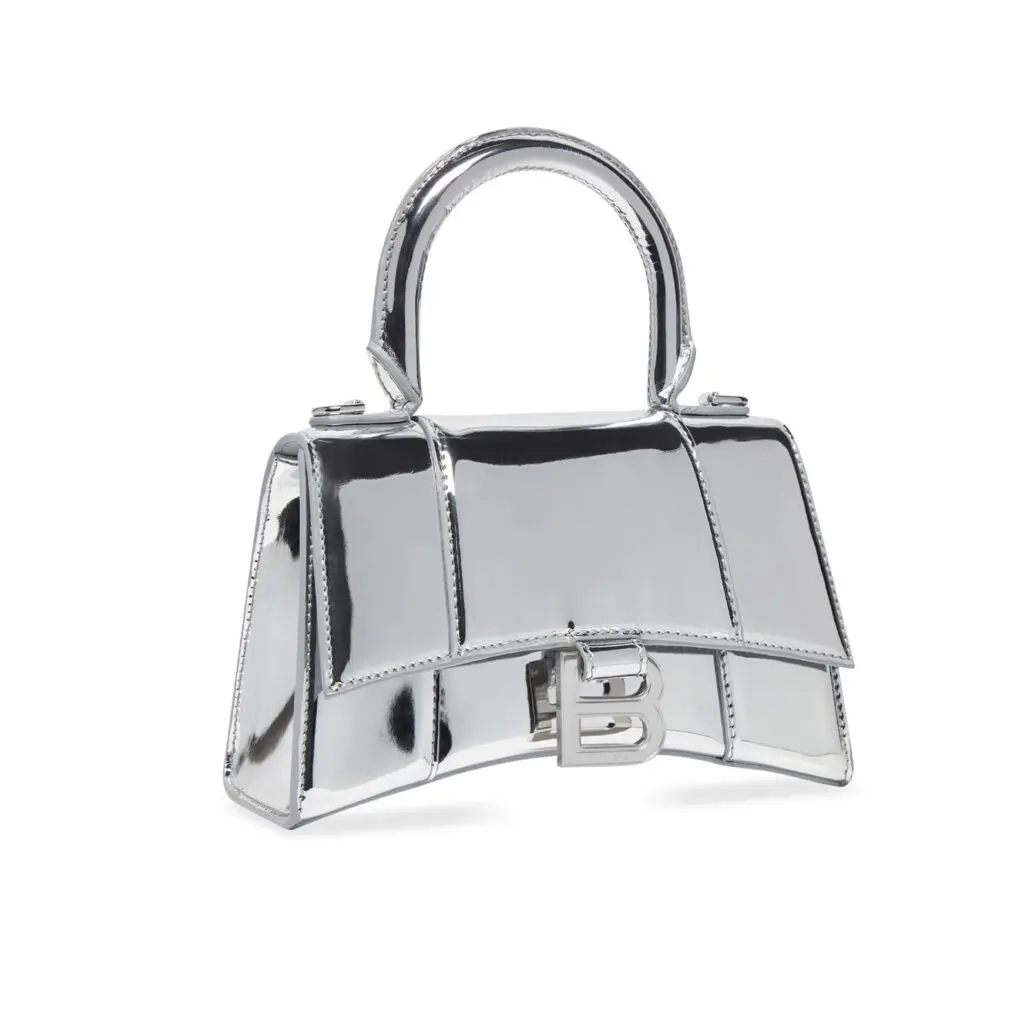 Balenciaga hourglass mirrored silver handbag with B logo.