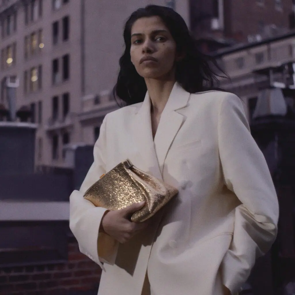 The Cannes clutch in gold metallic by DeMellier London.