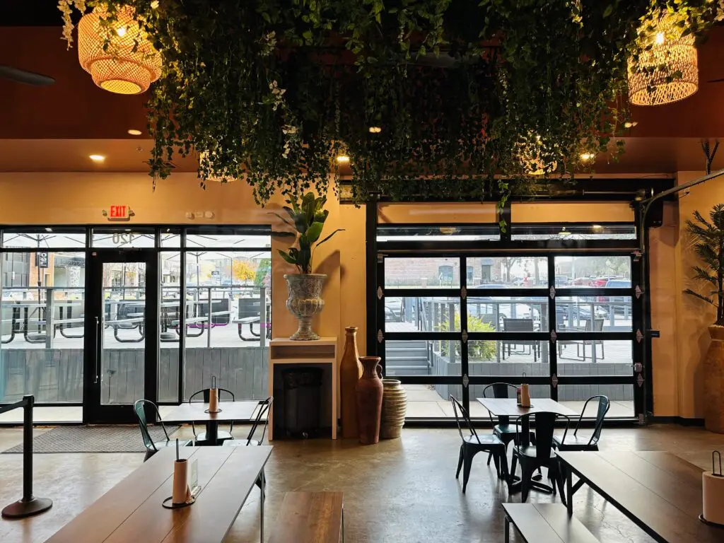 Greenery hangs overhead and garage doors stand a the ready for good weather.