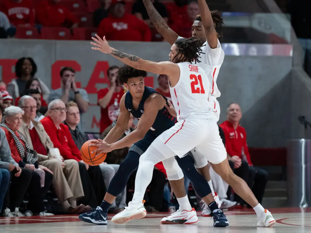 University of Houston's defense is relentless with Emanuel Sharp (No. 21) and Ja'Vier Francis all in. (Photo by F. Carter Smith)