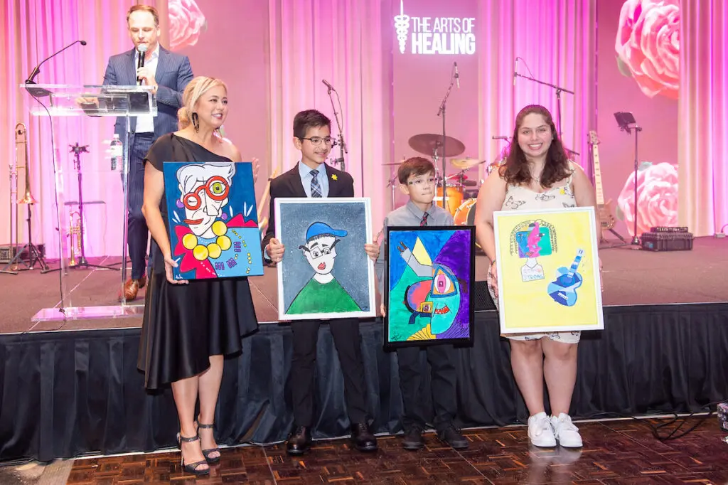 Jennifer Wisler with The Sunhine Kids displaying their artworks at the Arts of Healing Foundation Physician Art Show and Dinner at the Post Oak Hotel (Photo by Jacob Power)