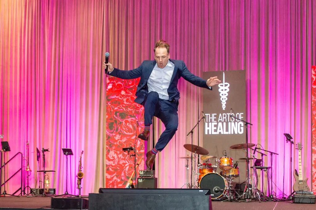 Jumping Johnny Bravo leading the live auction at the Arts of Healing Foundation Physician Art Show and Dinner at the Post Oak Hotel (Photo by Jacob Power)