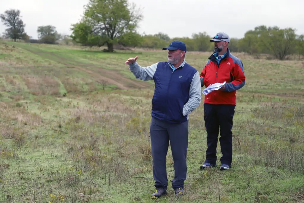 Designer Tripp Davis, with Kyle Downs, exploring the terrain of hole eleven as Kelly Ranch Golf Course takes shape.