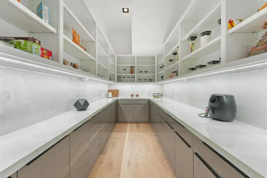The Butler's Pantry is a subtle addition to the kitchen, perfect for storing appliances and preparing meals. 