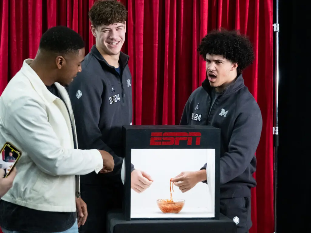 Michigan players play a game of “Identify This?” (It’s cold spaghetti!) during Media Day at the George R. Brown Convention Center as the City of Houston hosts the NCAA College Football Championship game with the University of Washington facing off against the University of Michigan at NRG Stadium. (Photo by F. Carter Smith)