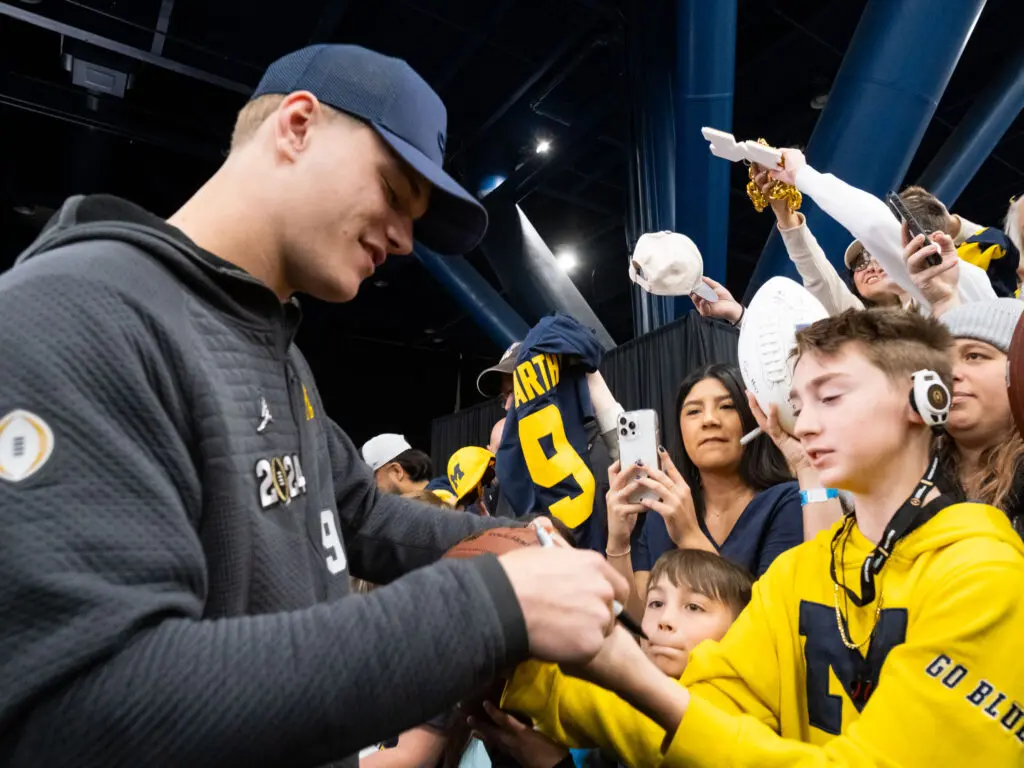 Michigan quarterback J.J. McCarthy signs for his fans in Houston. (Photo by F. Carter Smith)