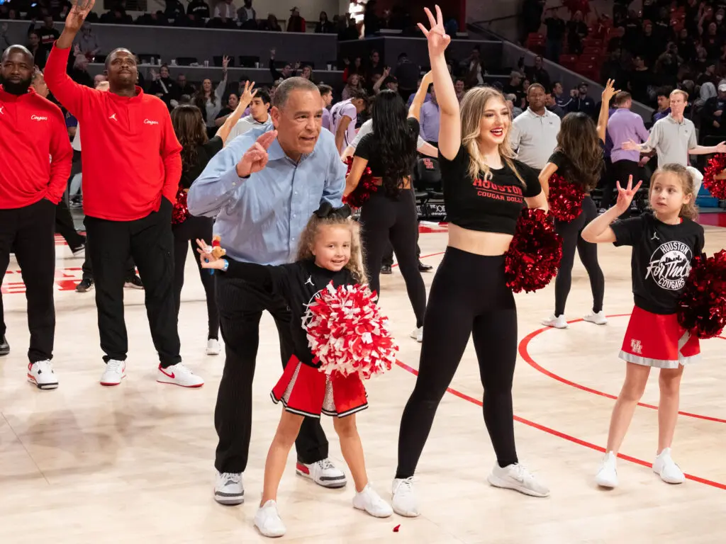 University of Houston coach Kelvin Sampson shared a moment with his cheerleader-loving granddaughter Maisy Jade after a win over Kansas State. (Photo by F. Carter Smith)