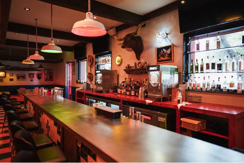 Decorated with vibrant and colorful lighting, bright blue-and-yellow checkered flooring underfoot and traditional Mexican art hung throughout the space, HiWay Cantina can seat 130 indoors and out, while the cozy bar seats sixteen. (Photo by Morgan Weber)