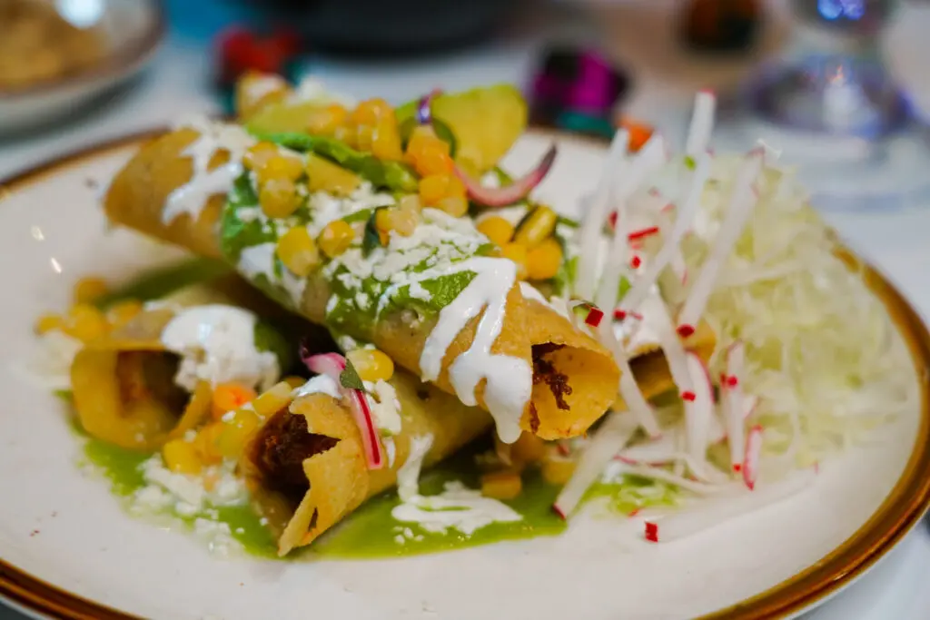 HiWay Cantina's green Chile chicken taquitos ($17.27) made with corn escabeche, avocado salsa, queso fresco and crema. (Photo by Mikah Danae)