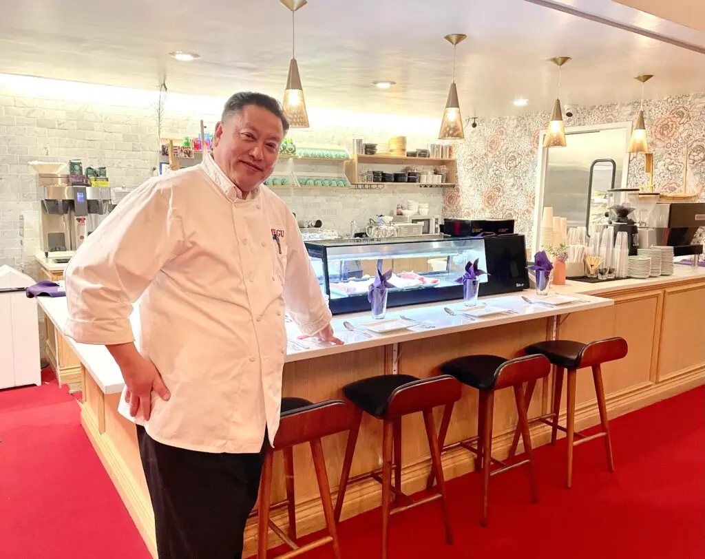 Owner and chef Peter Liang by the sushi bar at his new Megu French Japanese Cuisine. (Photo by Courtney Dabney)