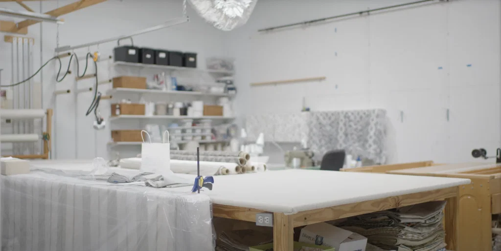 The workroom at Charbonneau Interiors has a large custom table, allowing the seamstress to easily manipulate larger lengths of fabric. (Photo by Charbonneau Interiors)