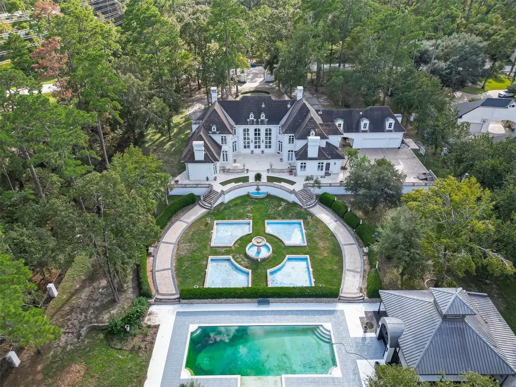 The stunning courtyard is an impressive feature of the mansion in The Woodlands at N Tranquil Path.