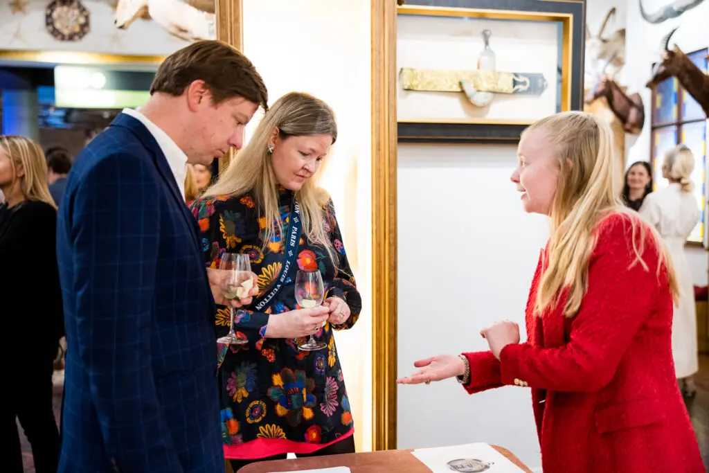 Ben Hobratsch, Laurence Unger learn about love tokens from Christine Dubbert at the Houston Museum of Natural Science H.P. Attwater Society event. (Photo by Hung L. Truong)