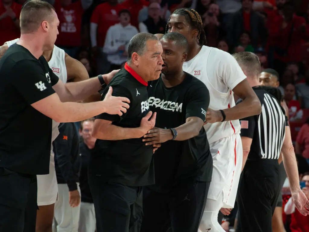 University of Houston coach Kelvin Sampson had to be held back as he got ejected. (Photo by F. Carter Smith)