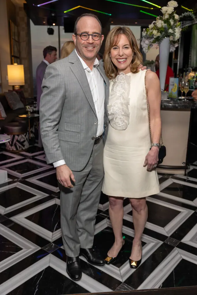 Steve & Debbie Sukin, Texas Children's Hospital president,, at the Texas Children's Houston Open Tee-Off in the penthouse suite at the Post Oak Hotel.  (Photo by Jenny Antill)