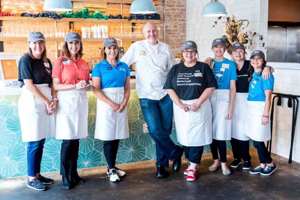 Chef Jeff Williams surrounded by volunteer staff who regularly serve at Taste Project.