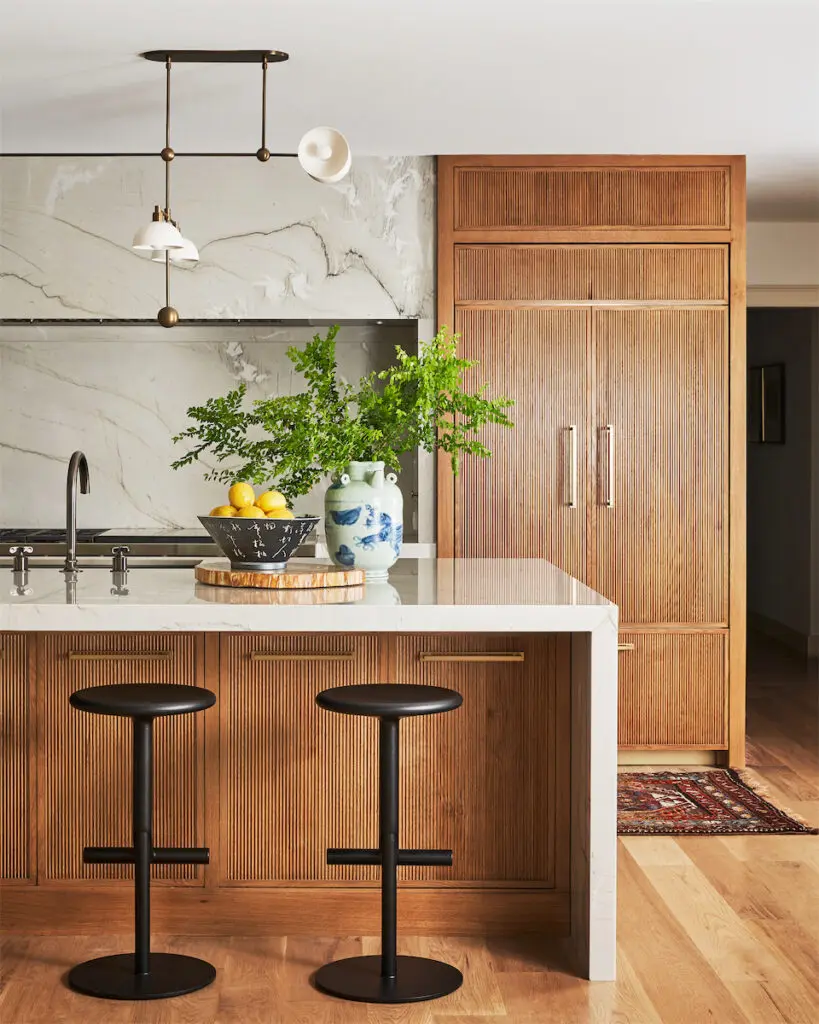 The kitchen’s white oak cabinetry was designed by Philip Thomas Vanderford. Jonathan Browning light pendants. Magis stools. (Photo by Stephen Karlisch)