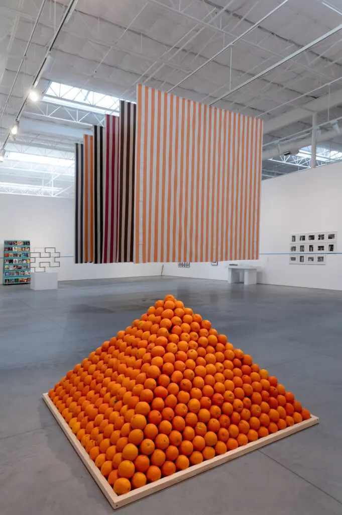 "For What It’s Worth: Value Systems in Art since 1960," The Warehouse, Dallas, installation view with work by
Roelof Louw, Ditte Ejlerskov and EvaMarie Lindahl, Sherrill Roland, Daniel Buren, André Cadere, Sanja Iveković, Minoru Hirata (3 works), Chris Burden (2 works), Lorraine O’Grady, and Edward Krasinski, on view through June 29, 2024 (Photo by Kevin Todora)