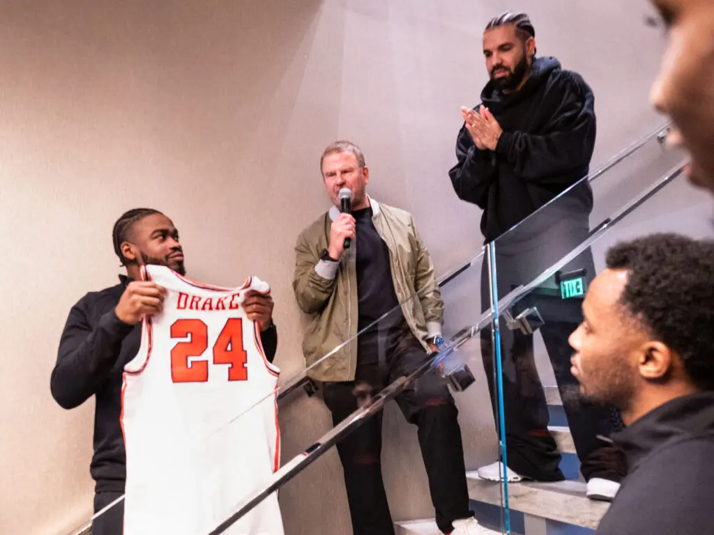 University of Houston point guard Jamal Shead and Tilman Fertitta presented Drake with his own UH jersey. (Photo by F. Carter Smith)