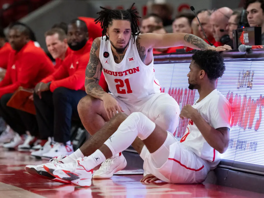 University of Houston guard Emanuel Sharp gives Mylik Wilson some pointers before they check in. (Photo by F. Carter Smith)