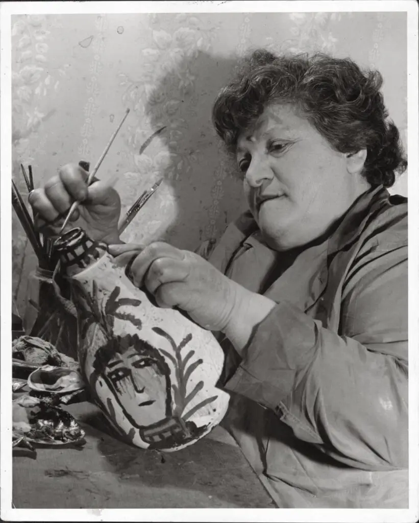 Artist Janet Sobel paints one of her artworks.