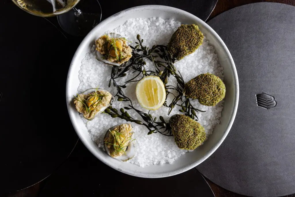 To start at Bar Bludorn, oysters ($4 each) can be fried, baked, or enjoyed raw. (Photo by Lauren Holub Photography)