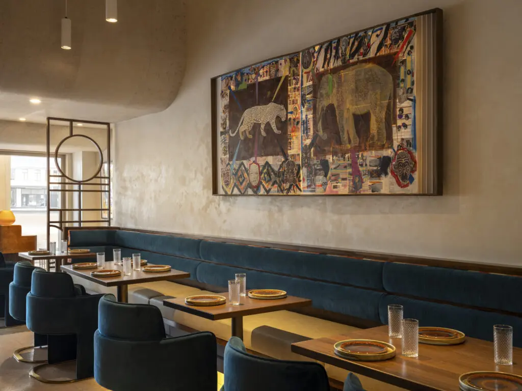 The original terrazzo flooring remains throughout Late August, including beneath the custom marble bar, while a commissioned piece by Houston artist and Hogan Brown Gallery curator Robert Hodge takes center stage. (Photo by Leonid Furmansky)
