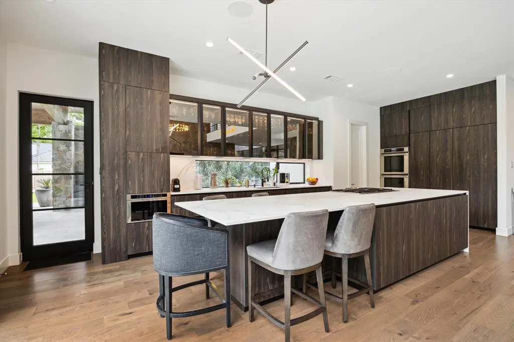 The kitchen is sleek with modern appliances and an expansive island for socializing.  (Photo by TK Images)