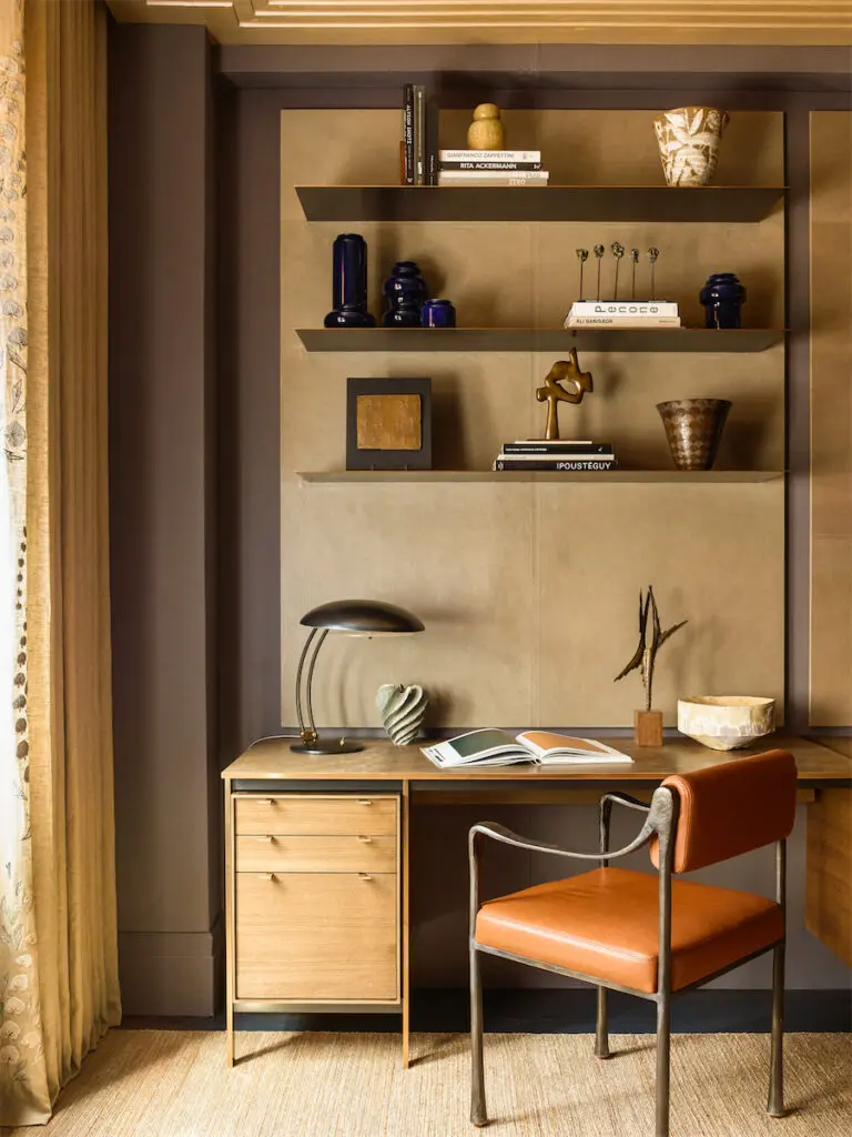 Custom cashmere-and-leather KGBL wall system, vintage bronze desk chair. Pierre Frey draperies with Combray raffia embroidery trim. (Photo by Eric Piasecki)