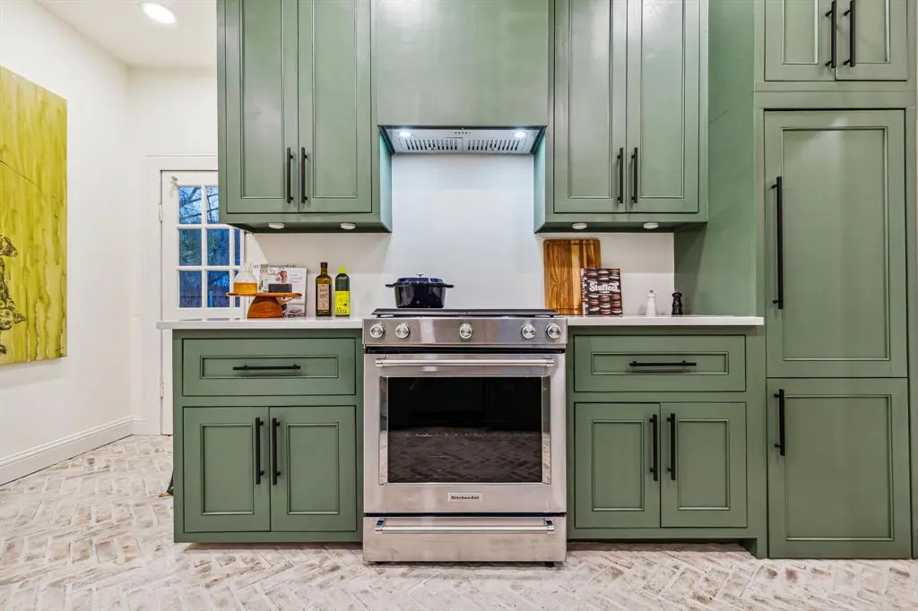 Kitchen cabinets are doused in an equestrian green.
