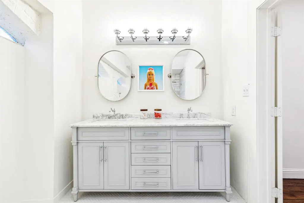A bathroom with double sinks.