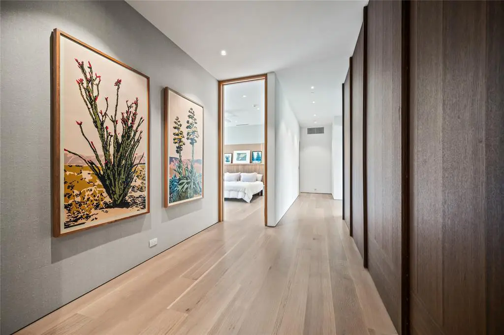 Natural light seeps into a windowless hallway. 