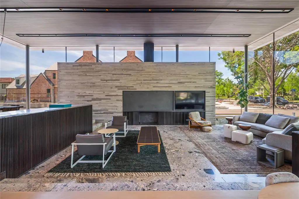 The living area feels intimate in the sprawling, glass-lined space.