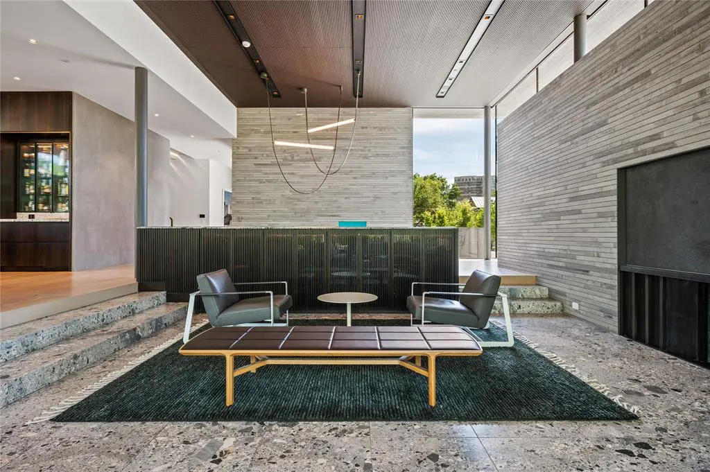 The living area feels intimate in the sprawling, glass-lined space.