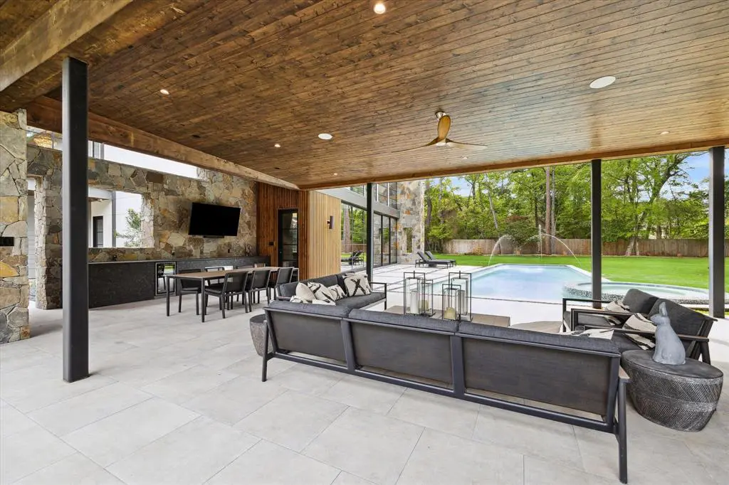 In the backyard, you can enjoy several places including an outdoor kitchen, lounge space, and TV area. (Photo by TK Images)