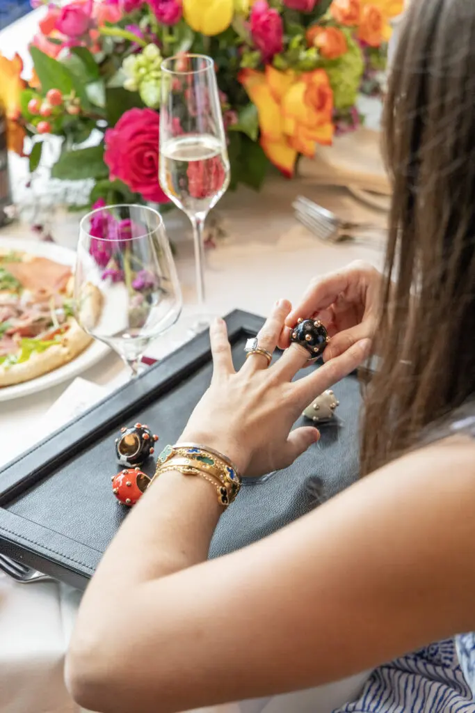 Guests try on rings from the Giorgio B collection at the de Boulle Diamond & Jewelry lunch at Bari (Photo by Jordan Geibel)