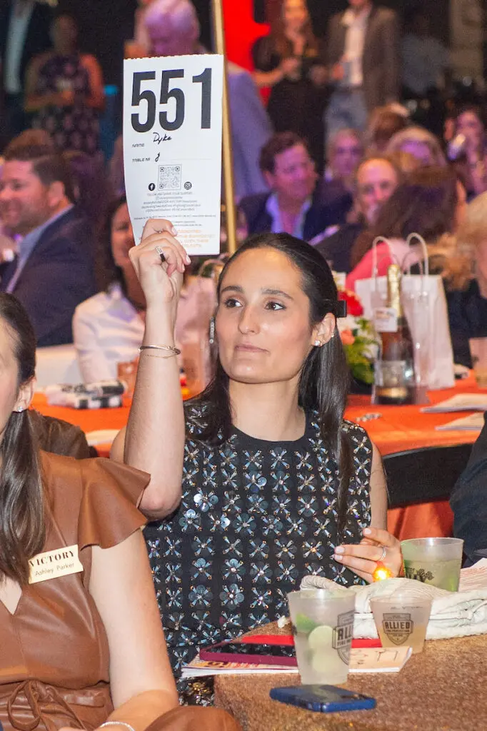 Erin Dyke bidding at the VICTORY Rally Ball (Photo by Jacob Power)