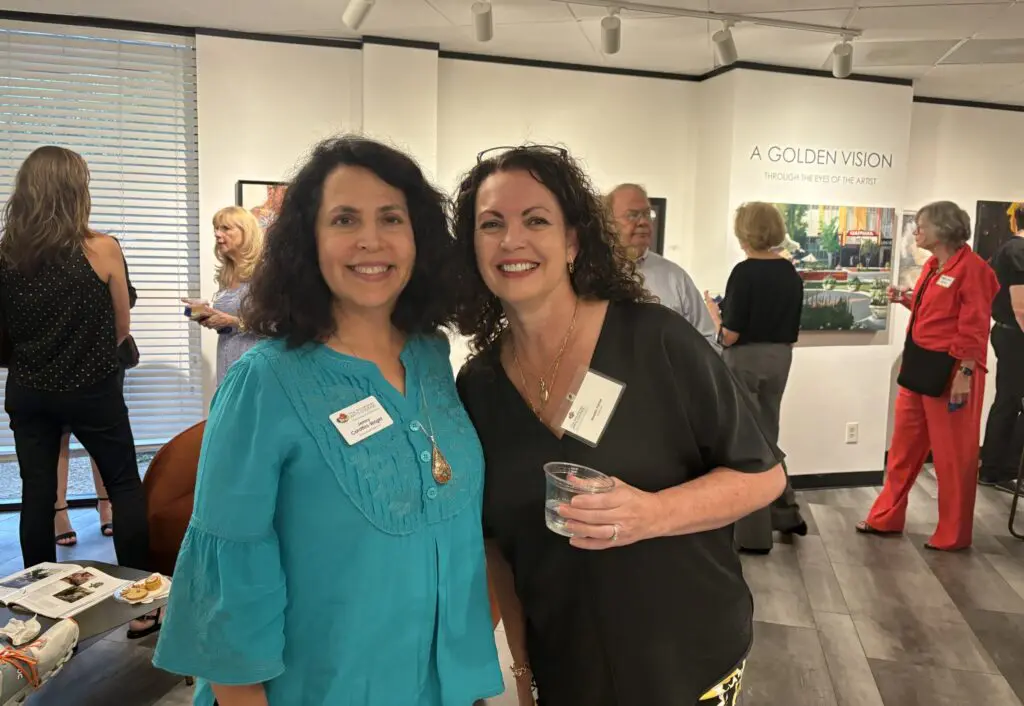 Jenny Carattini-Wright (l) and Annette Palmer at the opening for "A Golden Vision" show at the offices of The Woodlands Arts Council.  The exhibit runs through July 11. (Photo by Laura Landsbaum)