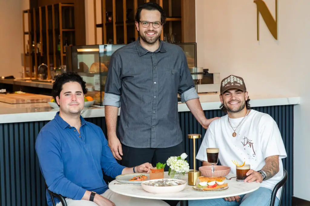 The owners of the new Maven Coffee + Cocktails Juan Carlos Martinez de Aldecoa, Nicolás “Nico” Baizán de Aldecoa and Lance McCullers Jr. settle into the new shop in The Thompson hotel. (Photo by Becca Wright)