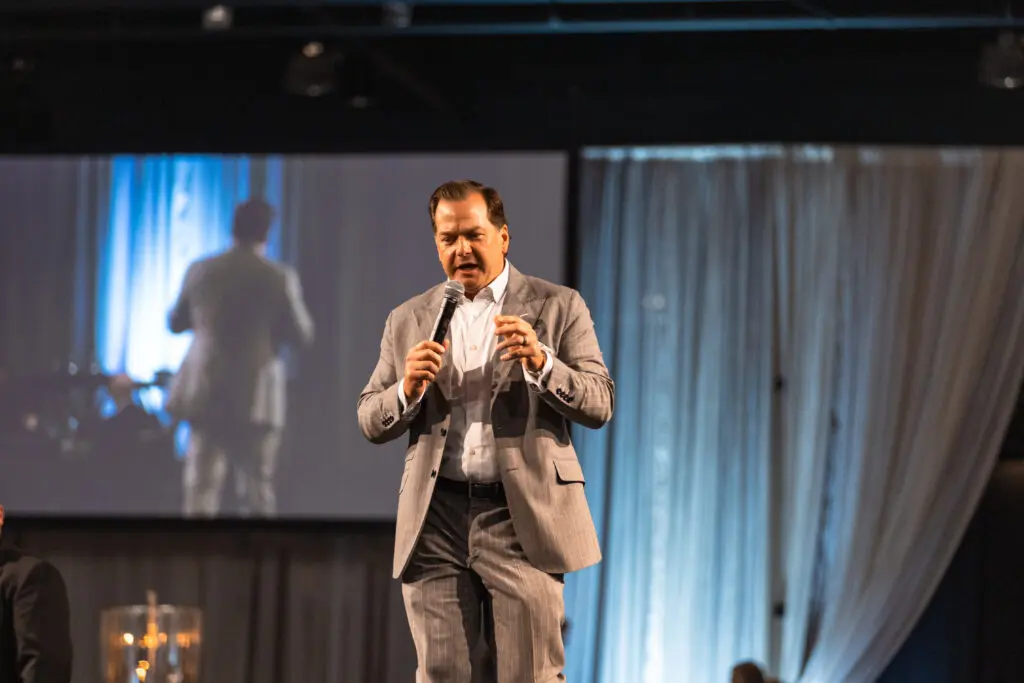 Will Murphy, master of ceremonies, kicking off the live auction which contributed greatly to the nearly $1.6 million raised at the “Now & Then” Celebrating 30 Years” – The Woodlands Christian Academy’s (TWCA) 2024 Auction & Gala.


