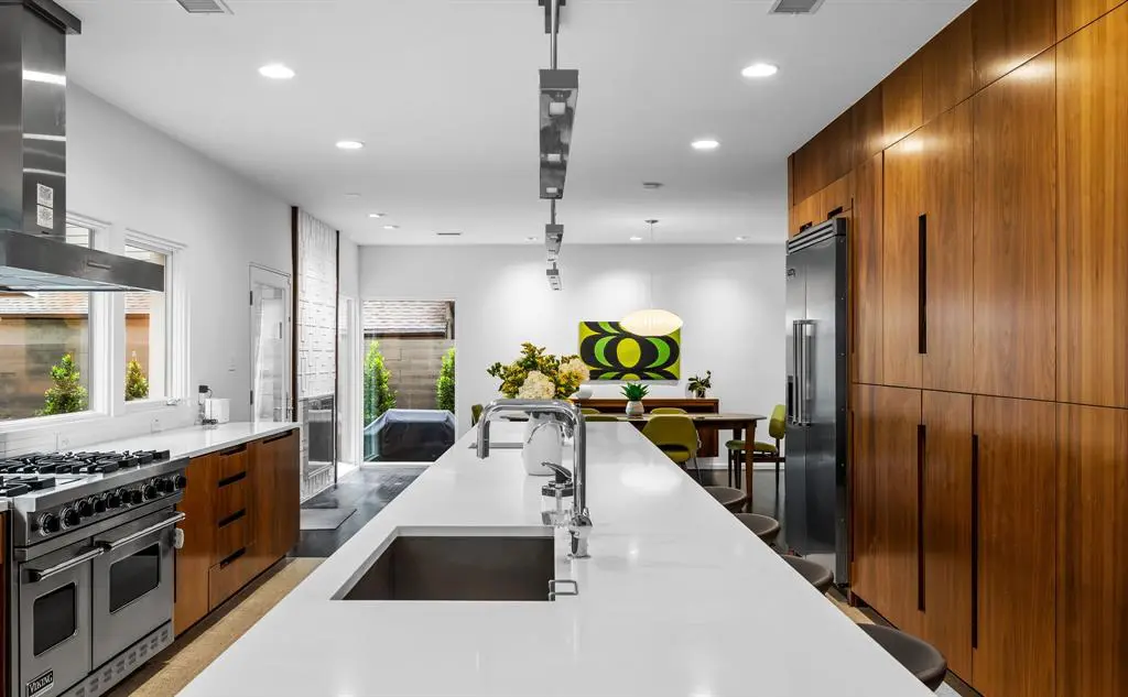 The kitchen features a six-burner range by Viking and a built-in refrigerator. 