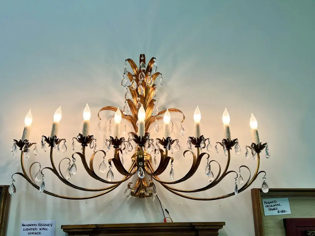 A Hollywood Regency wall sconce.