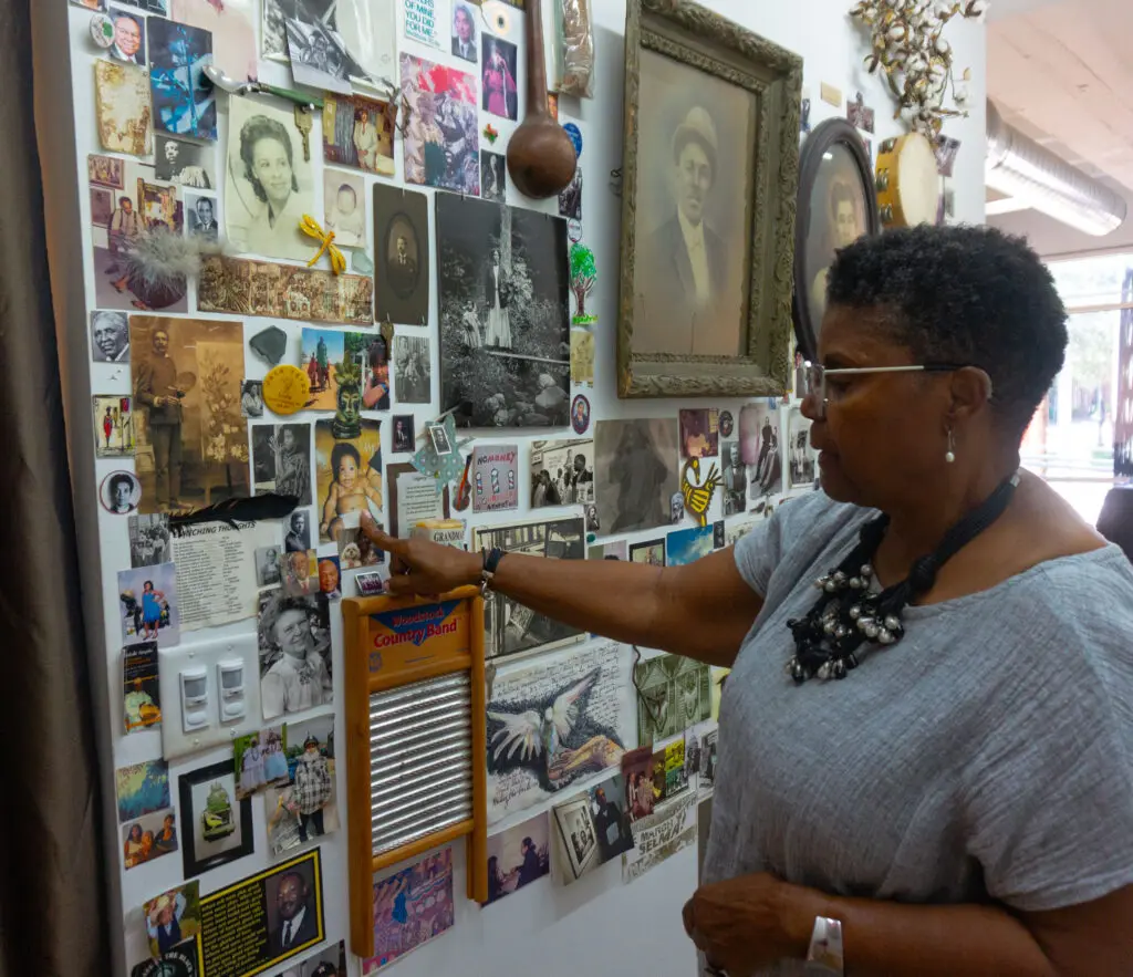 Merion Sherrod shows off the "Ancestors Wall" at The Community Artists' Collective Ashé Summer Market (Photo by Sofia Westerman) 