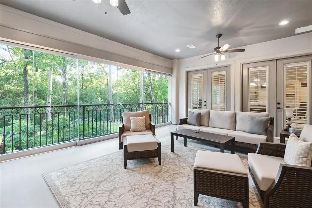 The enclosed balcony overlooks the outdoor pool, perfect for summer cocktail parties. 
