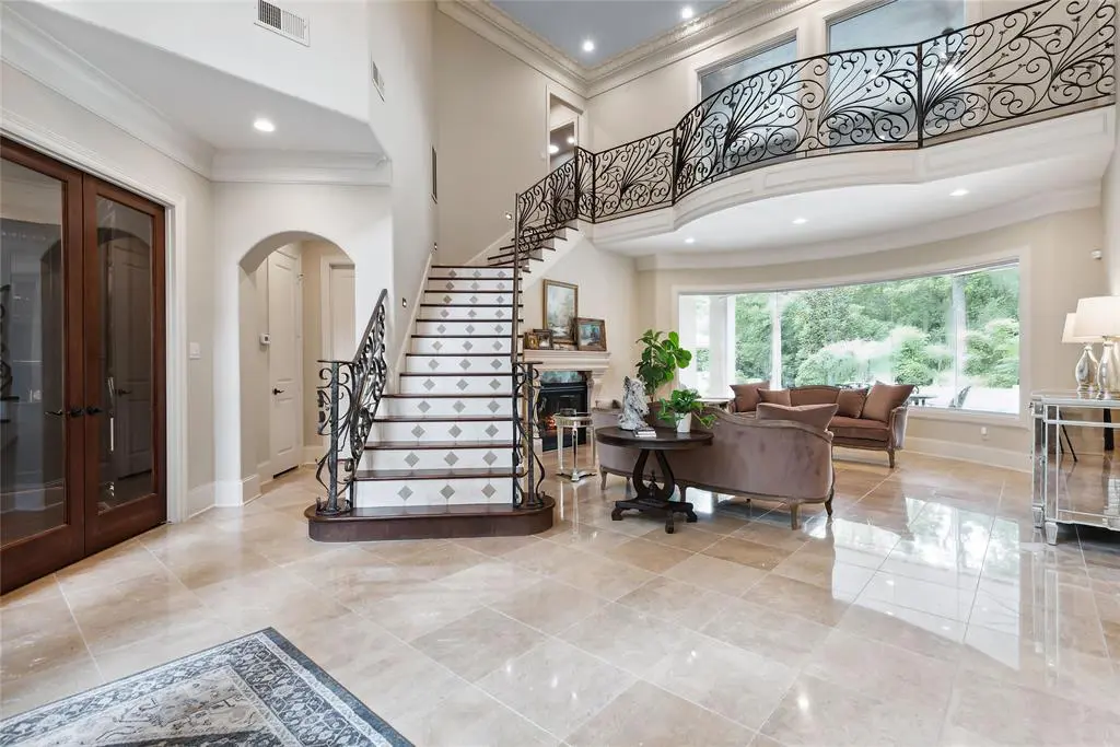 Entryway at 235 Angel Leaf Rd The sweeping staircase is a dramatic feature of this Grogan's Point mansion. It catches the eye as soon as you enter.