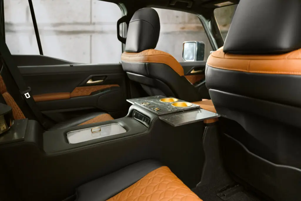 The second row in the Lexus Monogram GX is outfitted with a cold console compartment inside its lavish two-toned leather environment.