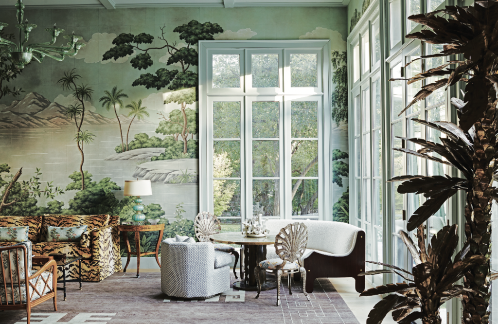 The living room walls are enveloped in Gracie’s New World panoramic landscape wallpaper. Italian 1950s banquette from Paul Bert Serpette antiques at Puces de Paris Saint-Ouen. Vintage grotto chairs from Ceylon et Cie. Upholstered chair from The Bright Group. Mid-Century brass table by Philip and Kelvin LaVerne from Collage. Ceramic sculpture on table by Anat Shiftan from Hostler Burrows, L.A. Custom rug designed by Julie Hayes from Interior Resources. Custom sofa in Nobilis tiger velvet. Vintage Venetian glass lamp from John Gregory Studios.  (Photo by Richard Powers)