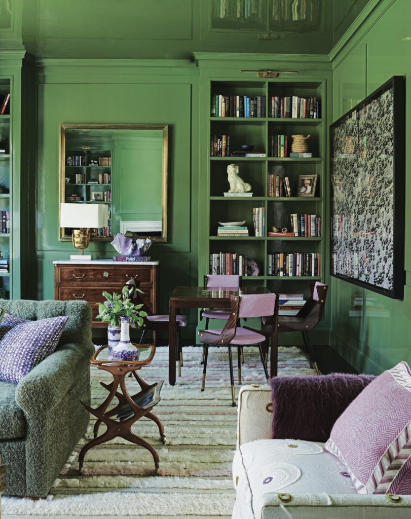 The library walls are lacquered in Benjamin Moore Oak Grove. Italian mid- century magazine table and chest from Jean-Marc Frey, Austin. Julie Hayes designed the custom rug by Interior Resources. Embroidered upholstery on chair is Kravet; custom pillow in Loro Piana cashmere.  (Photo by Richard Powers)